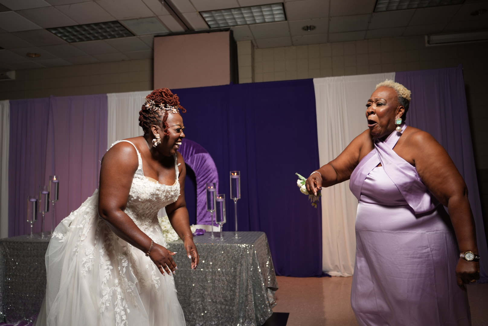 Bride laughing with a guest during the bouquet toss.