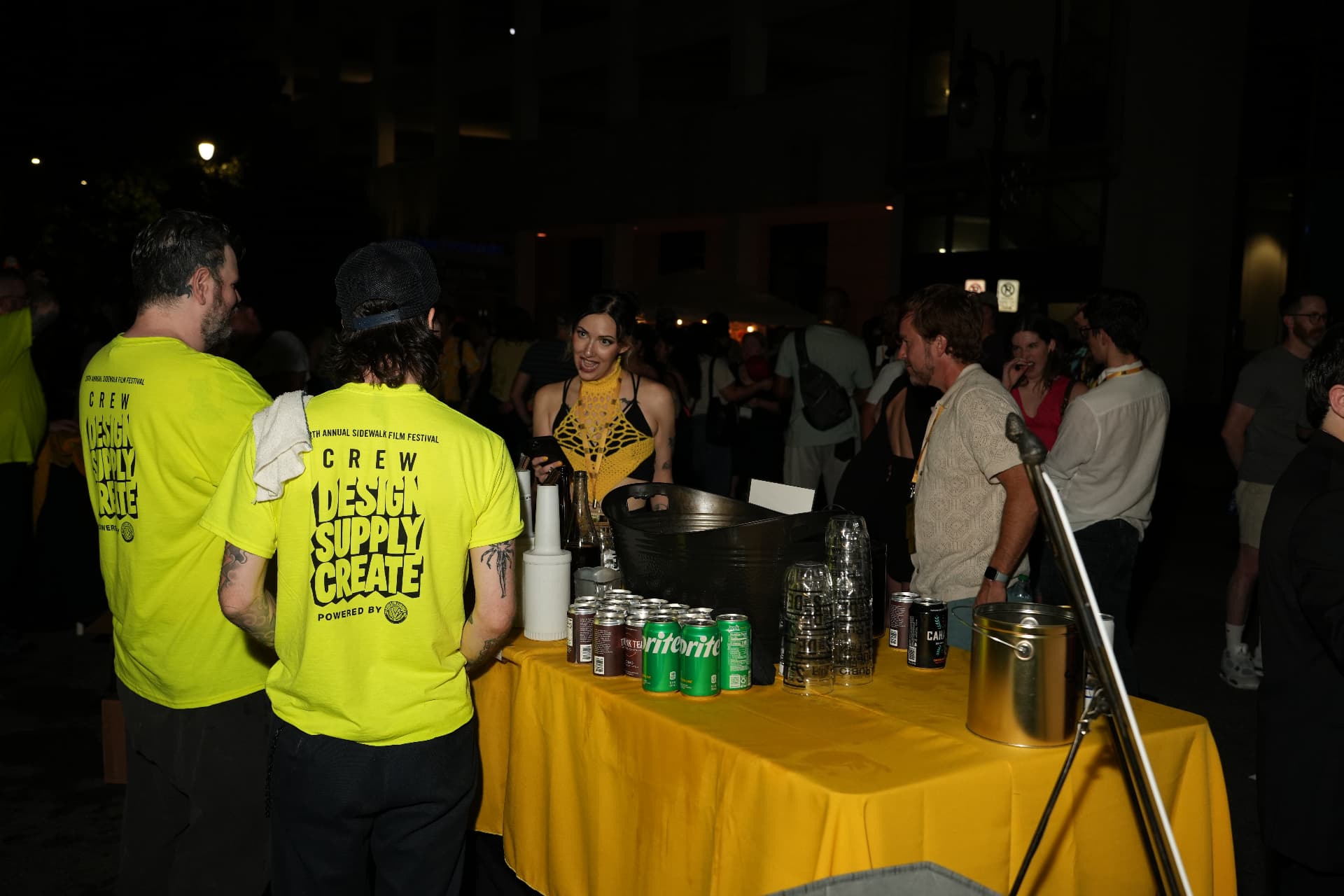 Night event coverage at the Sidewalk Film Festival crew table.
