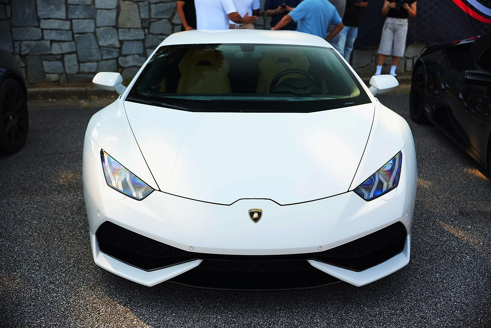 White Lamborghini Huracán photographed head-on at a car meet.