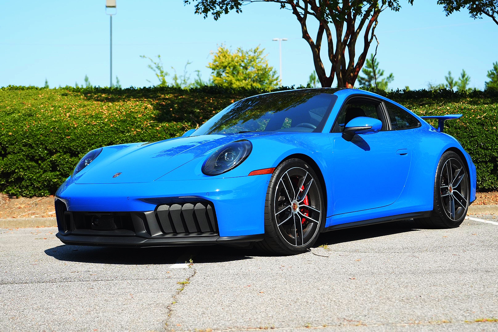 Blue Porsche 911 GTS photographed from the front three-quarter angle.