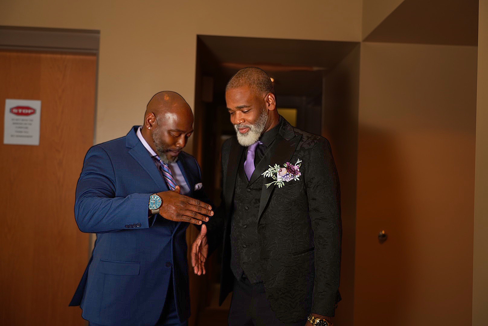Groom and groomsman sharing a moment before the ceremony.