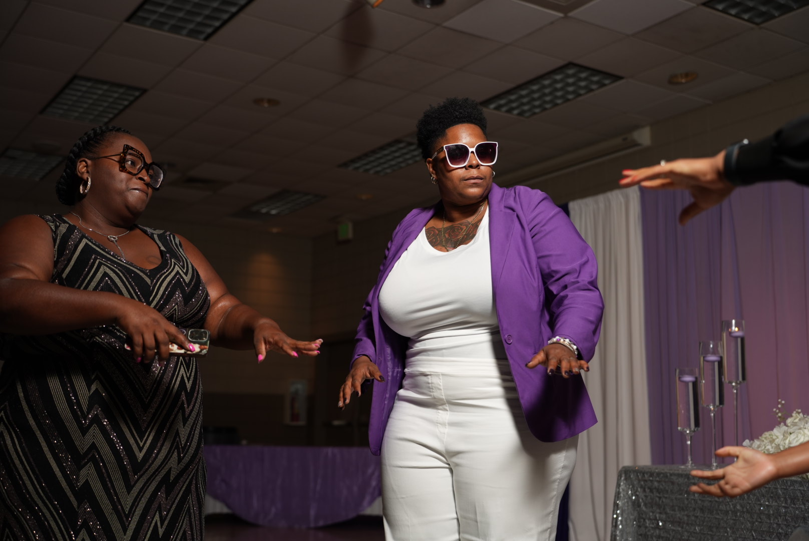 Guests dancing during a purple-themed wedding reception.