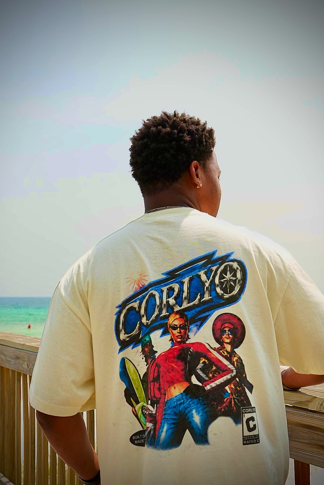 Beach boardwalk portrait featuring the CORLYO Étoile graphic back print.