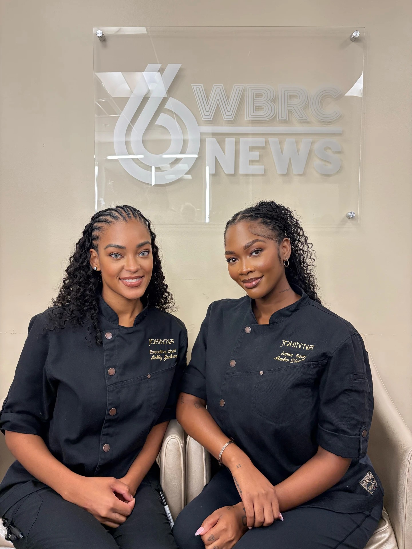 Two chefs photographed in front of the WBRC 6 News sign.