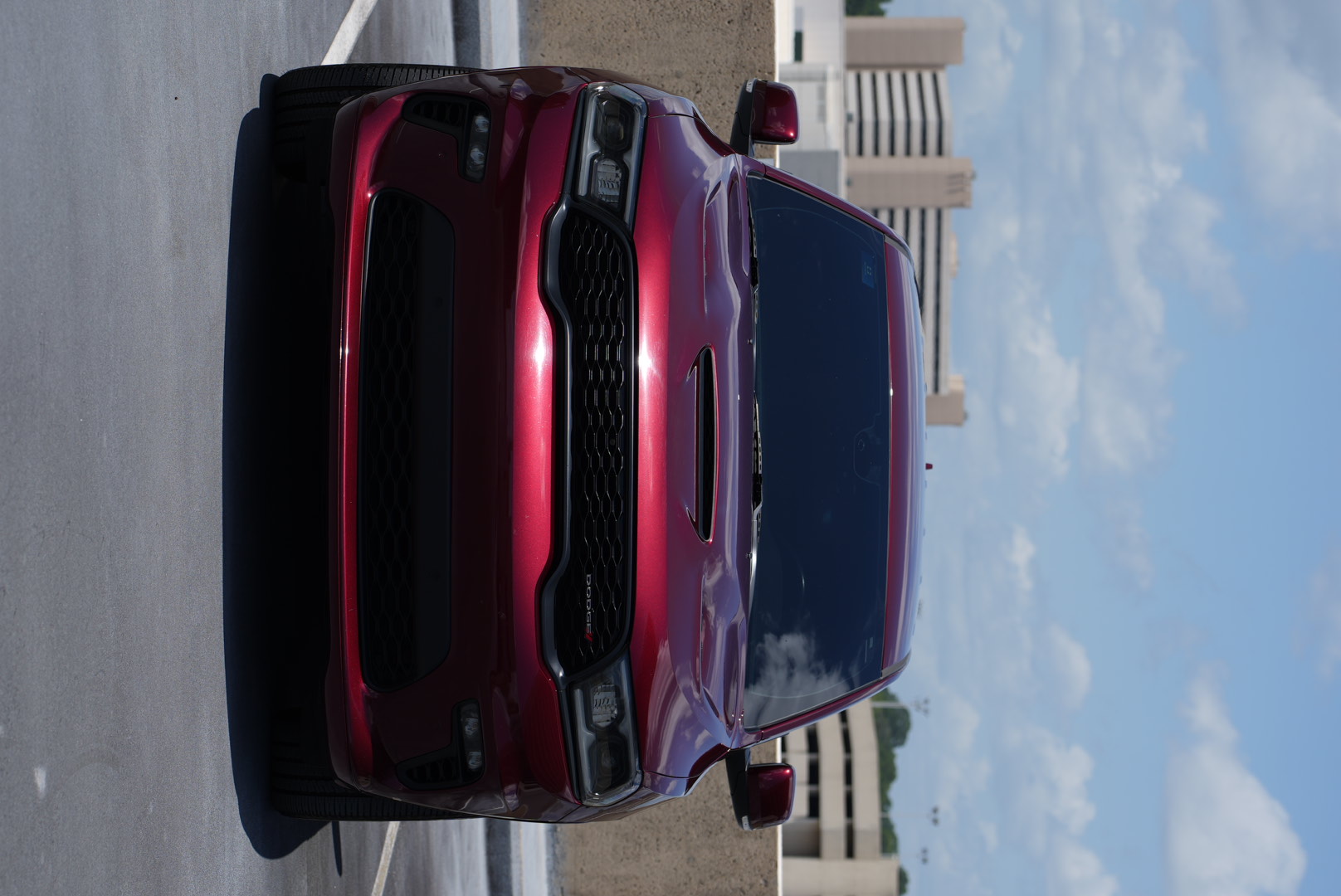 Red Dodge Durango photographed head-on in a rooftop parking deck.