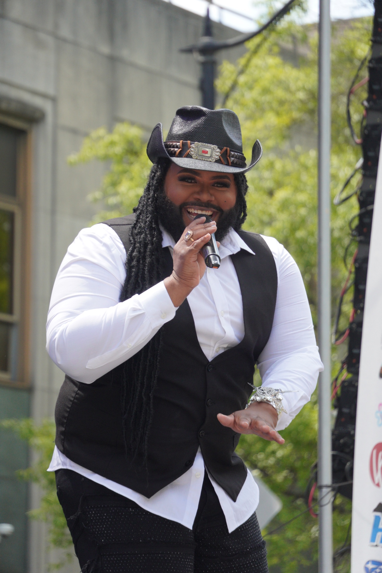 Performer on stage in a cowboy hat photographed mid-set.